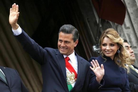 Mexico's President Enrique Pena Nieto and first lady Angelica Rivera salute during the military parade celebrating Independence Day at the Zocalo square in downtown Mexico City