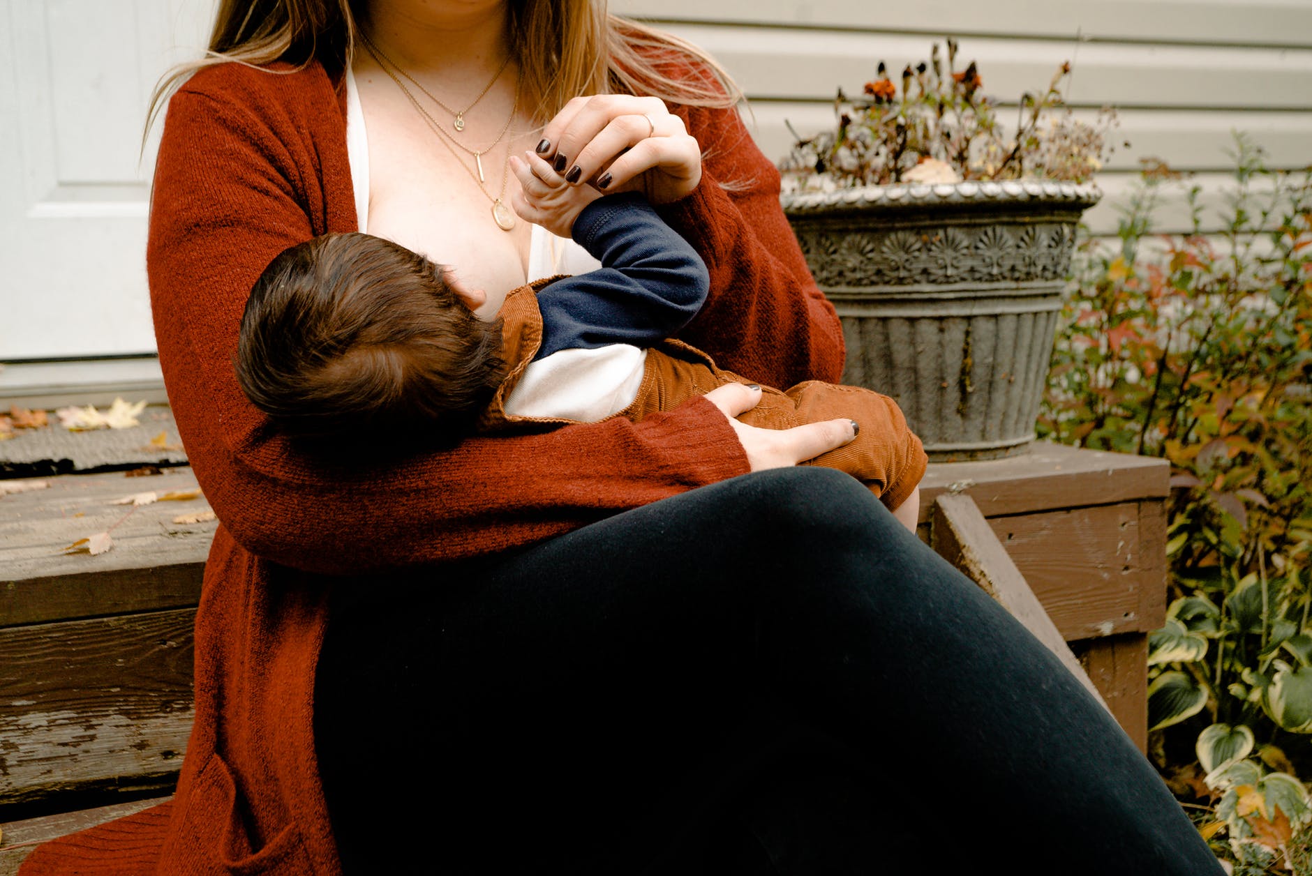 photo of woman breastfeeding her child